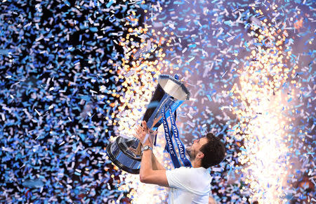 Tennis - ATP World Tour Finals - The O2 Arena, London, Britain - November 19, 2017 Bulgaria's Grigor Dimitrov celebrates with the trophy after winning the final against Belgium's David Goffin REUTERS/Toby Melville