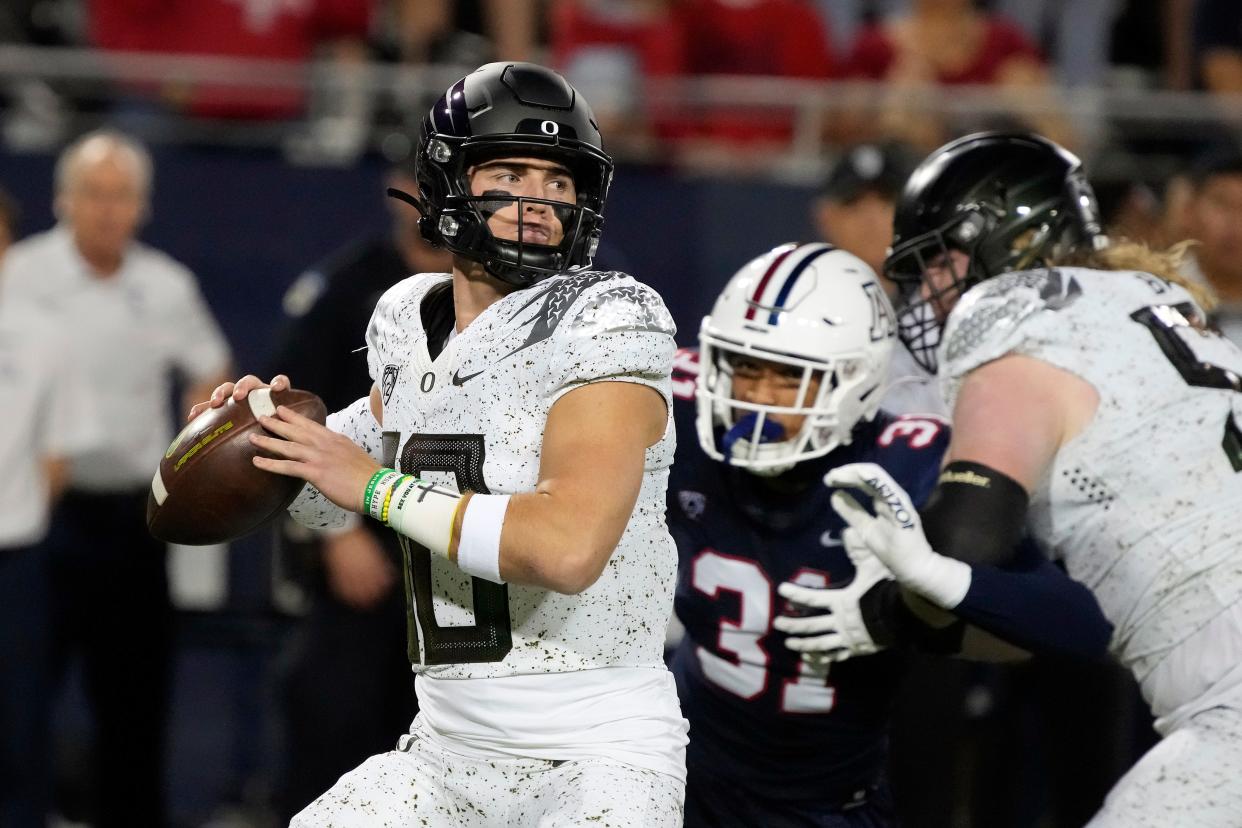 Oregon quarterback Bo Nix (10) looks for a receiver during the first half of the team's NCAA college football game against Arizona, Saturday, Oct. 8, 2022, in Tucson, Ariz. (AP Photo/Rick Scuteri)