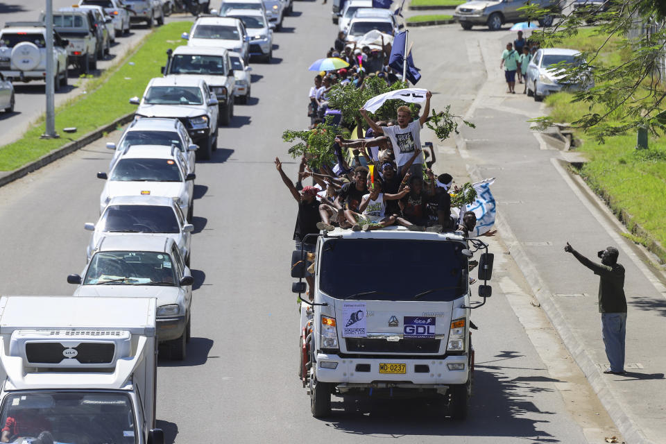 Locals react as they participate in a candidates parade in the capital Honiara, Solomon Islands, Monday, April 15, 2024. The country in which China has gained most influence in the South Pacific, Solomon Islands, goes to the polls on Wednesday in an election that could shape the region's future. (AP Photo/Charley Priringi)