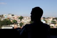 Erik Thiago looks out from his window, amid the coronavirus disease (COVID-19) outbreak, in Sao Paulo