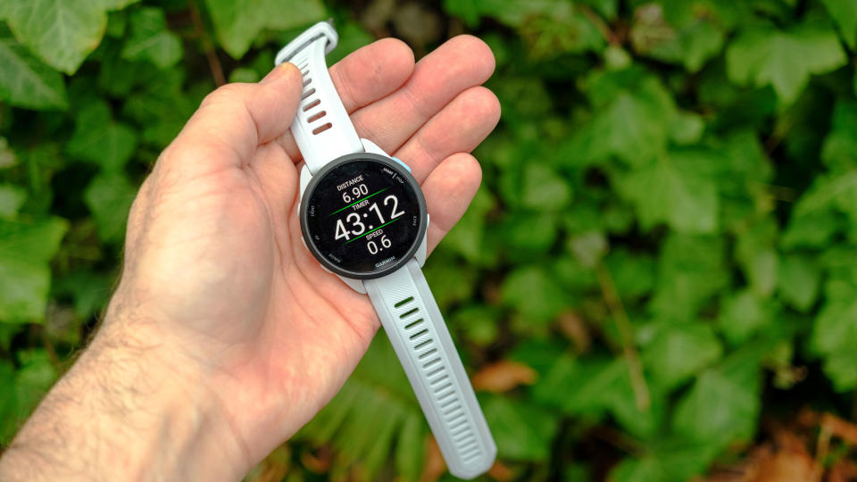 Garmin Forerunner 165 held in a person's hand