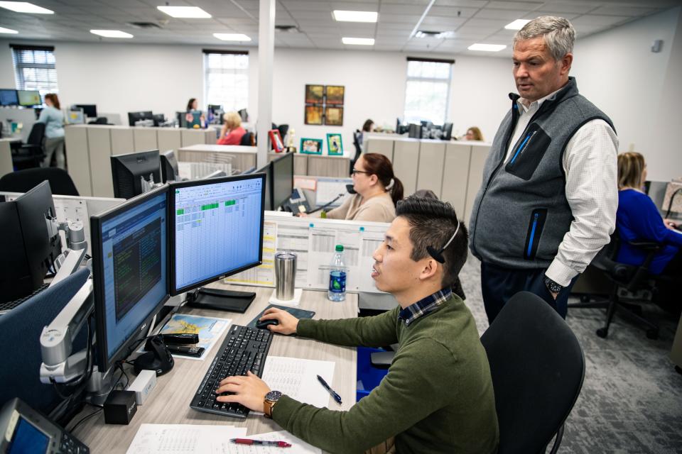Mike Murphy watches Sam Hong work in Cornerstone Systems' Intermodal Operations Department in Memphis.  The transportation company is 100% employee-owned.