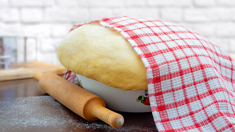 sourdough ball covered with towel