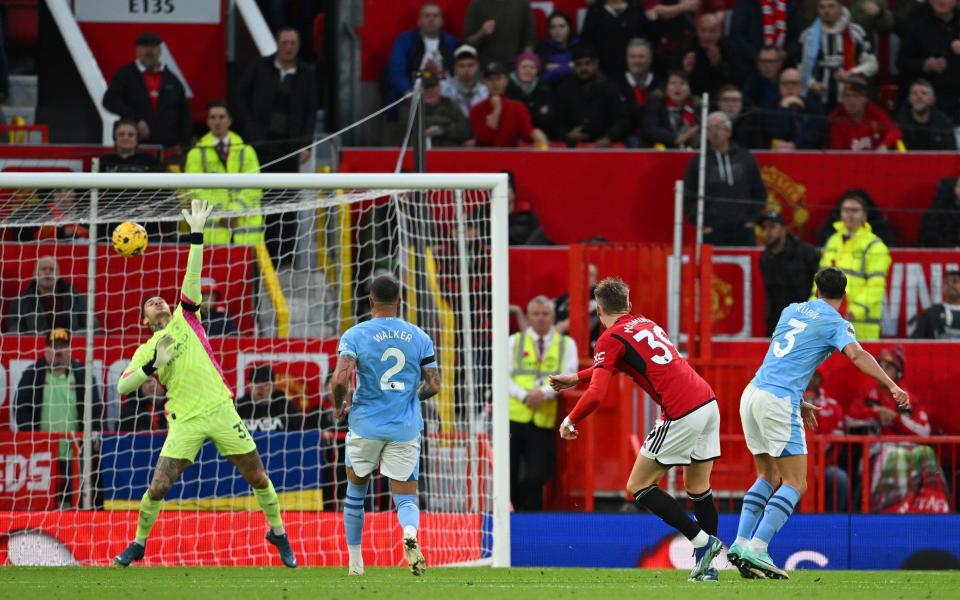 Ederson of Manchester City makes a save from Scott McTominay of Manchester United