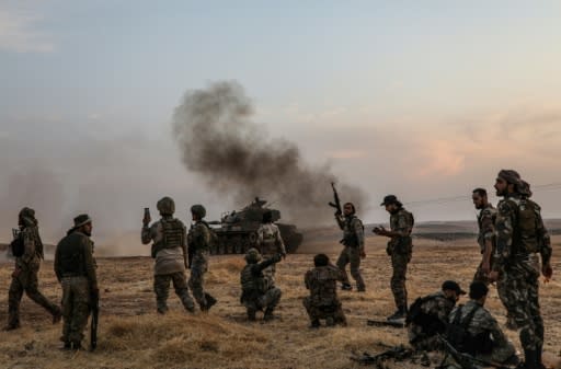 Turkish soldiers and Turkey-backed Syrian fighters on the outskirts of the Syrian city of Manbij near the Turkish border