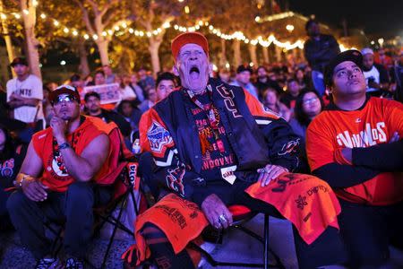 Howard "Crazy Legs" Lowe watches the San Francisco Giants and the Kansas City Royals play the World Series during a television viewing event at the Civic Center in San Francisco, California October 29, 2014. REUTERS/Robert Galbraith