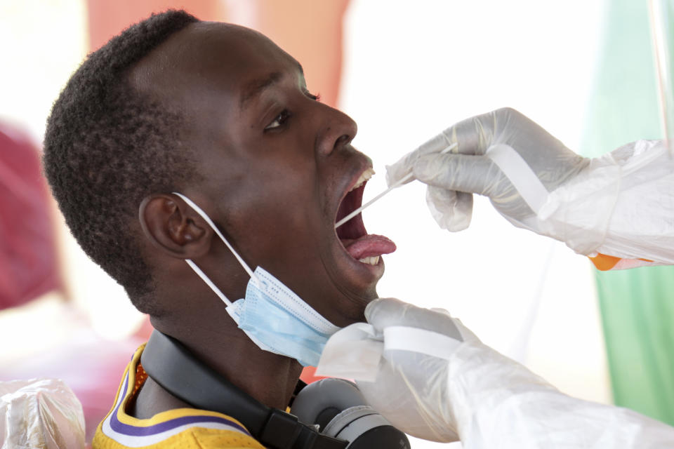 A member of the public is tested for the coronavirus in Bujumbura, Burundi Monday, July 6, 2020. Burundi launched a campaign of mass screening for COVID-19 on Monday in the country's largest city Bujumbura, indicating that the new president Evariste Ndayishimiye is implementing policies to combat the spread of the disease. (AP Photo/Berthier Mugiraneza)