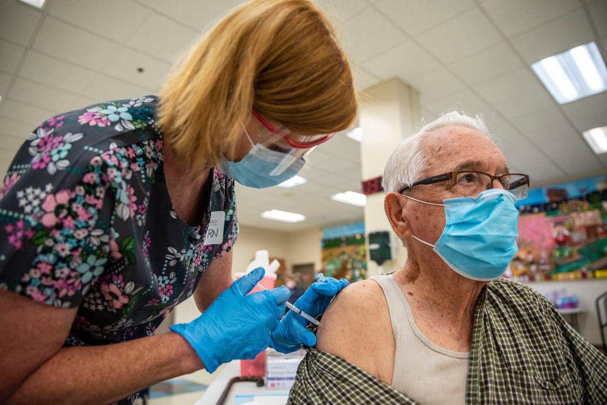 Rene Neira receives his Moderna COVID-19 vaccine at a vaccination site at a senior center on March 29, 2021, in San Antonio, Texas.