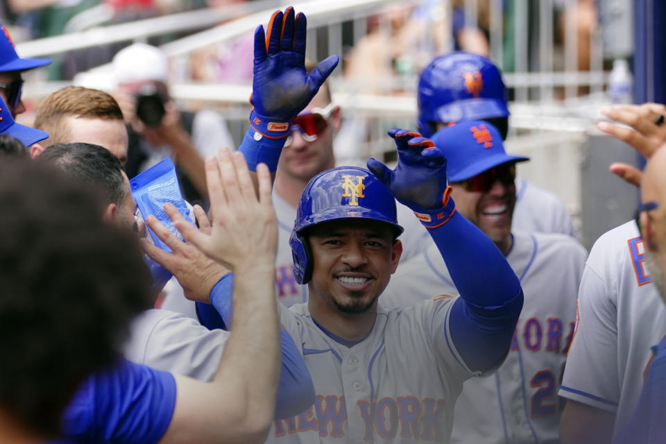 New York Mets' Eduardo Escobar celebrates after hitting a solo home run in the second inning of a baseball game against the Atlanta Braves, Wednesday, July 13, 2022, in Atlanta. (AP Photo/John Bazemore)