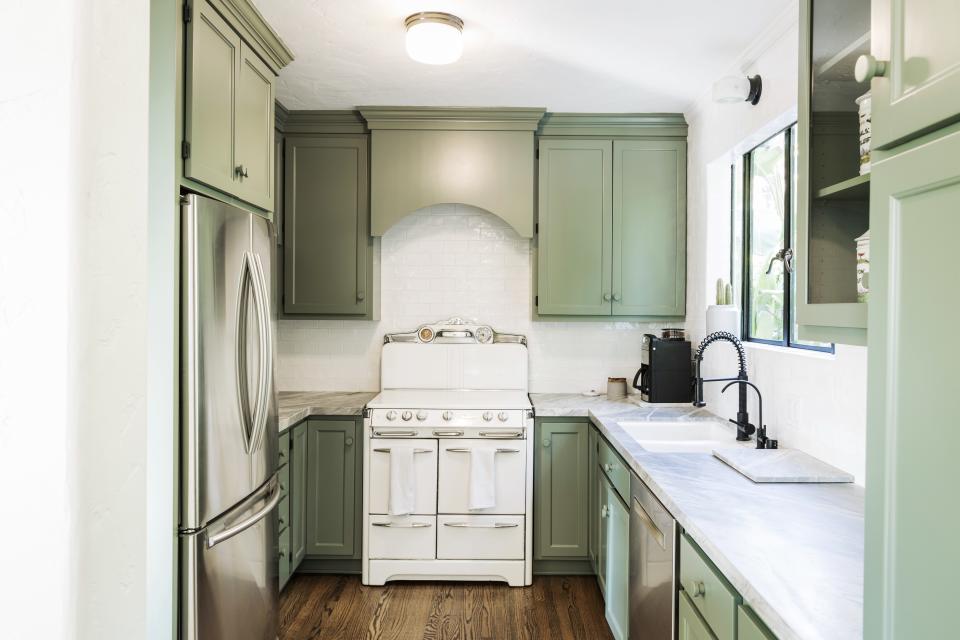 The couple fully renovated the kitchen, which was 40s-style, down to the bright yellow linoleum flooring. But they kept its original stove.