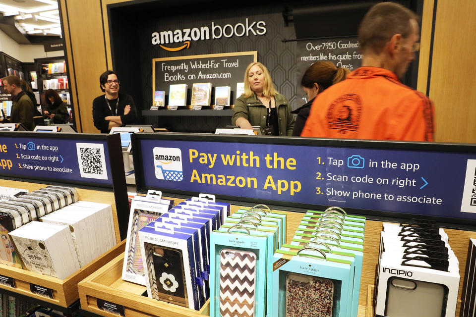 People shop in the newly opened Amazon Books on May 25 in New York City. Amazon Books, like the Amazon Go store, does not accept cash and instead lets Prime members use the Amazon app on their smartphone to pay for purchases. Non-members can use a credit or debit card. (Photo: Spencer Platt via Getty Images)