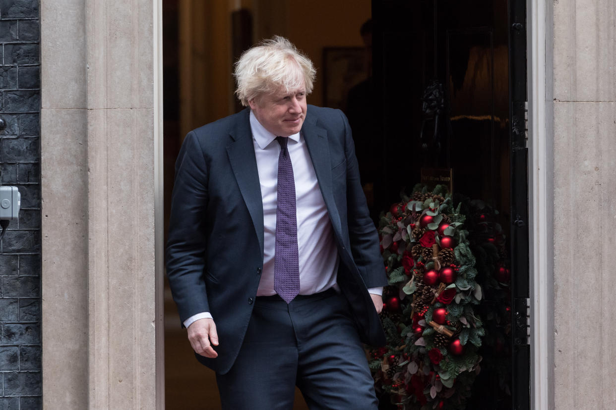 LONDON, UNITED KINGDOM - DECEMBER 03, 2021: British Prime Minister Boris Johnson steps out from 10 Downing Street to welcome Sultan of Brunei Hassanal Bolkiah (not pictured) ahead of their bilateral meeting on December 03, 2021 in London, England. (Photo credit should read Wiktor Szymanowicz/Future Publishing via Getty Images)