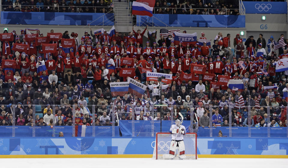 Supporters of Russian athletes cheer behind U.S. goalie Ryan Zapolski. (AP Photo/Matt Slocum)