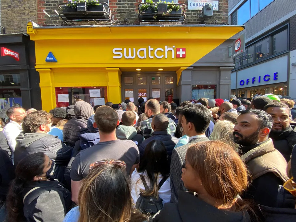 Customers congregate at the doors to the closed Swatch store on Carnaby Street, central London, after chaos broke out at the launch of the MoonSwatch, with late customers trying to barge their way into the store ahead of those who had waited in line overnight. The Omega x Swatch collaboration is a collection of solar system-inspired watches based on Omega's Moonwatch, the first wristwatch worn on the moon, but available for a fraction of the price. Picture date: Saturday March 26, 2022. (Photo by Yui Mok/PA Images via Getty Images)