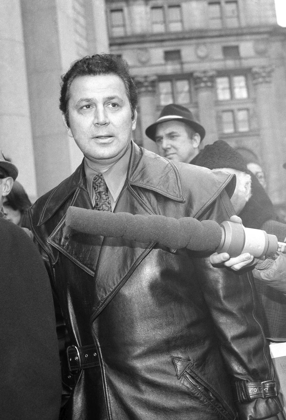 FILE - Photographer Ron Galella arrives at U.S. District Court in New York, on Feb. 16, 1972, where he is suing Jacqueline Onassis charging that she interfered with his livelihood. Celebrity photographer Galella has died at age 91. A spokesperson says Galella died Saturday, April 30, 2022, at his home in Montville, N.J., of congestive heart failure. (AP Photo/Anthony Camerano, File)