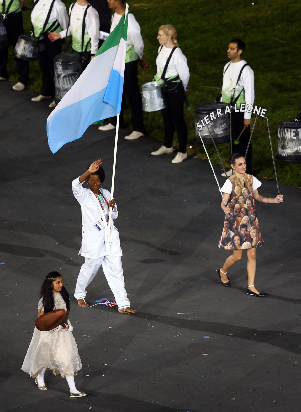 LONDON, ENGLAND - JULY 27: Ola Isata Sesay of the Sierra Leone Olympic athletics team carries her country's flag during the Opening Ceremony of the London 2012 Olympic Games at the Olympic Stadium on July 27, 2012 in London, England. (Photo by Paul Gilham/Getty Images)