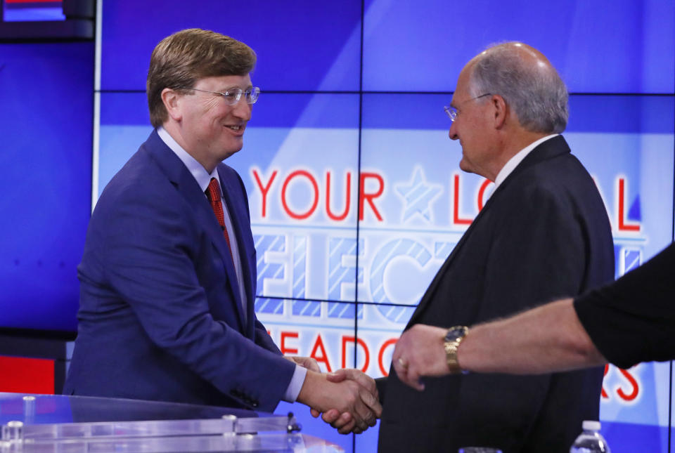 Lt. Gov. Tate Reeves, left, shakes the hand of his GOP gubernatorial runoff opponent former Mississippi Supreme Court Chief Justice and gubernatorial candidate Bill Waller Jr., in Jackson, Miss., Wednesday, Aug. 21, 2019, prior to the start of their televised debate. (AP Photo/Rogelio V. Solis)