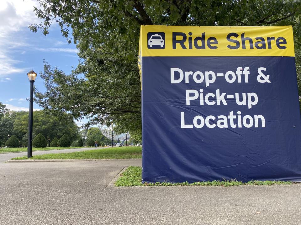 us open, ride share pick up and drop off location with unisphere in background, flushing meadows corona park, queens, new york