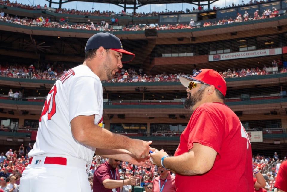Cardinals' player Adam Wainwright greets Terry Badger II before the game against the Yankees Sunday, July 2, 2023. The team honored Badger's son, Terry Badger III, who dreamed of playing for the Cardinals, but died by suicided in March.