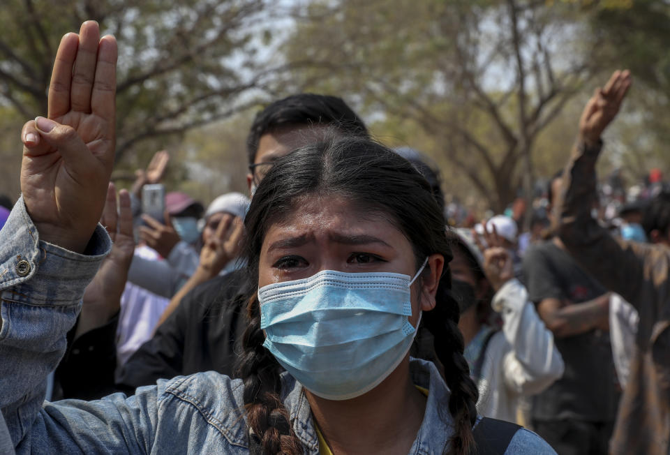 A woman cries during the burial of anti-protester Kyal Sin in Mandalay, Myanmar, Thursday, March 4, 2021. Kyal Sin was shot in the head by Myanmar security forces during an anti-coup protest rally she was attending Wednesday. (AP Photo)