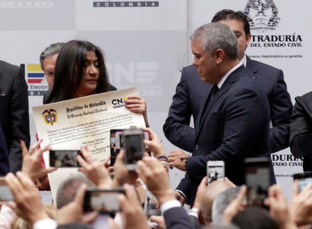 Colombia's President-Elect Ivan Duque receives his credentials from the election council, in Bogota, Colombia July 16, 2018. REUTERS/Luisa Gonzalez