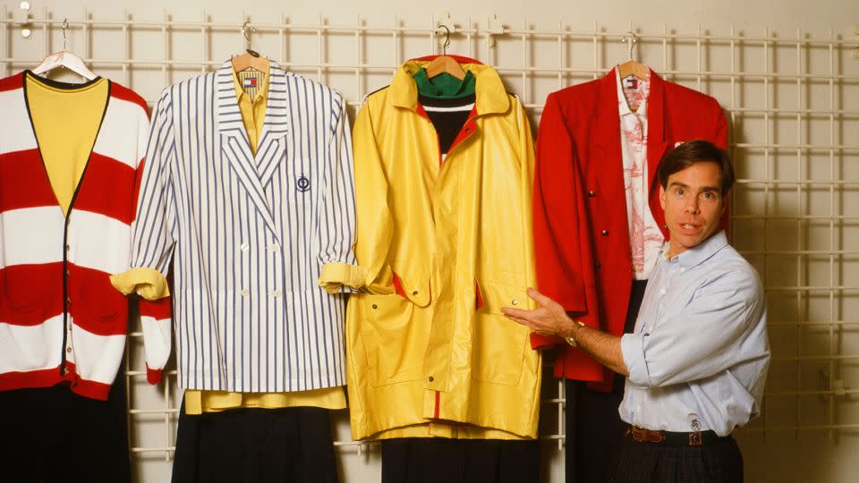 Tommy Hilfiger poses with his designs in his New York studio on September 10, 1987. - Robert R. McElroy/Archive Photos/Getty Images