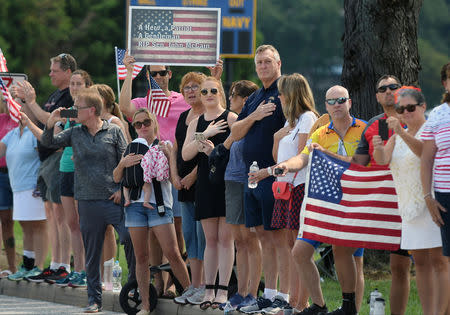 Spectators watch a hearse containing the body of the late Senator John McCain arrive for a private memorial service and burial at the U.S. Naval Academy in Annapolis, U.S., September 2, 2018. REUTERS/Mary F. Calvert