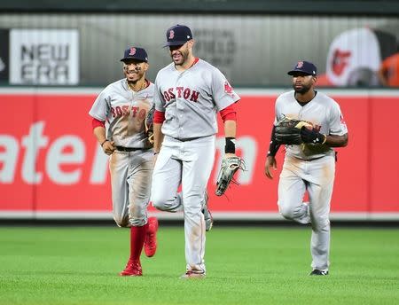 Aug 11, 2018; Baltimore, MD, USA; Boston Red Sox outfielders Mookie Betts (left), J.D. Martinez (center) and Jackie Bradley Jr. (right) celebrate after beating the Baltimore Orioles 6-4 at Oriole Park at Camden Yards. Mandatory Credit: Evan Habeeb-USA TODAY Sports