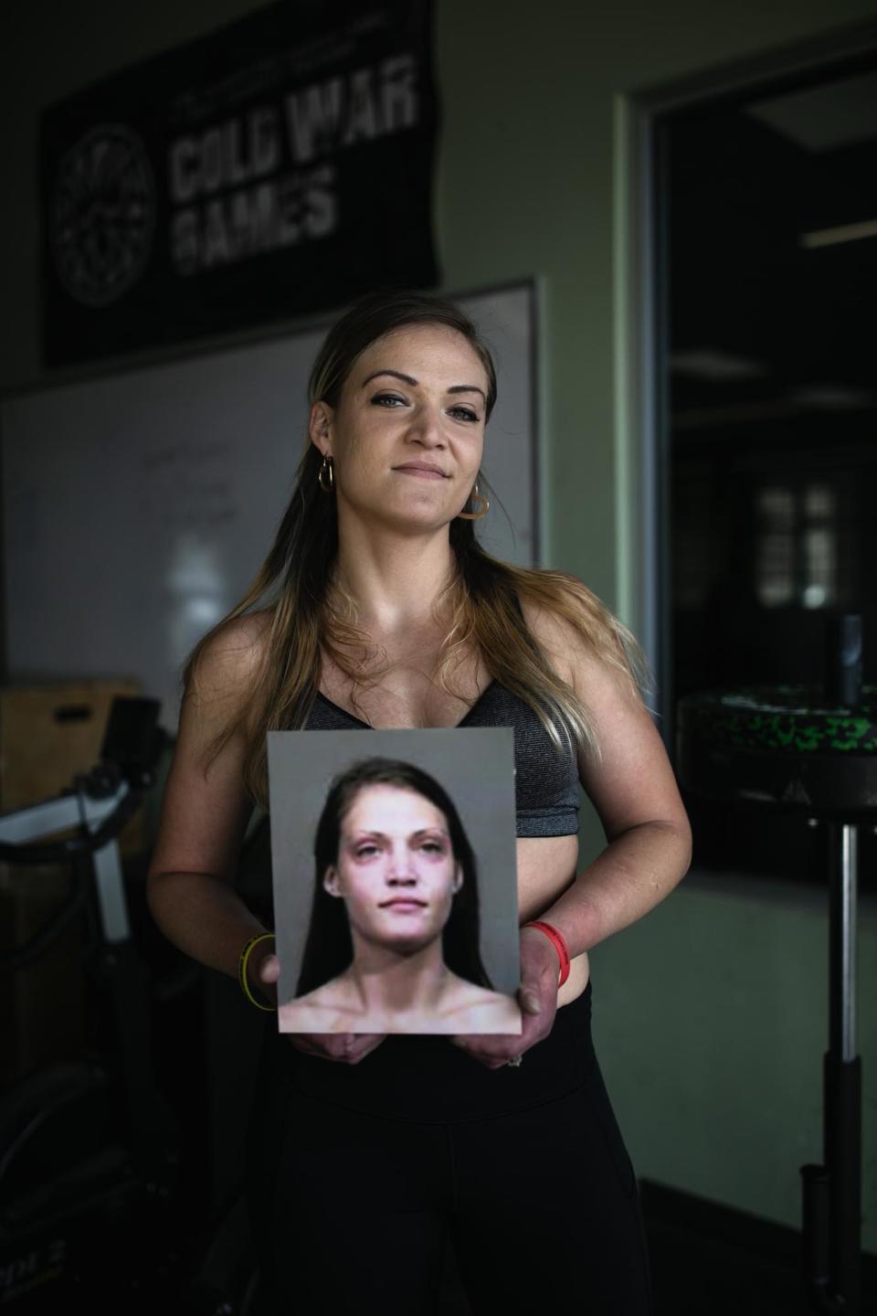 Kayla holds her mugshot at the gym in Portsmouth, OH on May 8, 2023.