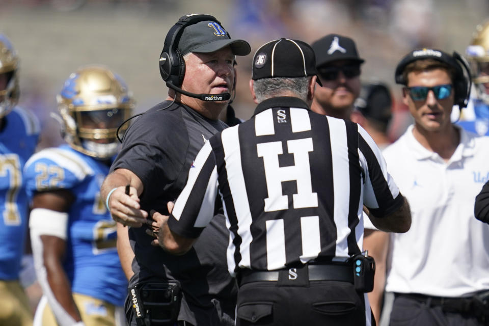 UCLA head coach Chip Kelly talks with an official during the first half of an NCAA college football game against Utah in Pasadena, Calif., Saturday, Oct. 8, 2022. (AP Photo/Ashley Landis)