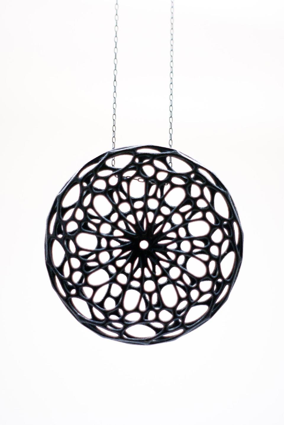 This undated publicity photo provided by Nervous System shows a black nylon plastic Cellular Pendant, created by designer Jessica Rosenkrantz. This and other pieces were inspired by cell-like structures found in nature. The design studio, Nervous System, in Somerville, Mass., prints art, jewelry and housewares in sterling silver, stainless steel and nylon plastic using 3D printer technology. (AP Photo/Nervous System, Jessica Rosenkrantz)