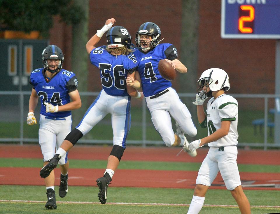 Dover-Sherborn senior captain Johnny Bennett (top right) celebrates his first touchdown reception with senior captain Derek Daly. Bennett scored twice in the Raiders' 28-7 win over on Sept. 17, 2021.