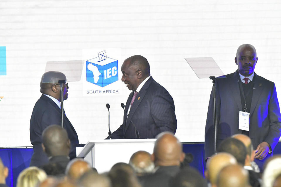 Mosotho Moepya (left), chairman of the Election Commission, announces the results of the election and declares them free and fair before handing over to President Cyril Ramaphosa (center) at the National Result Operation Centre (ROC) at Gallagher Estate, June 2, 2024 in Midrand, South Africa. / Credit: Sydney Seshibedi/Gallo Images/Getty