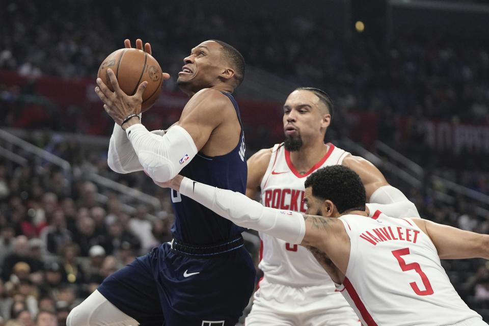 Los Angeles Clippers guard Russell Westbrook, left, shoots as Houston Rockets forward Dillon Brooks, center, and guard Fred VanVleet defend during the first half of an NBA basketball In-Season Tournament game Friday, Nov. 17, 2023, in Los Angeles. (AP Photo/Mark J. Terrill)