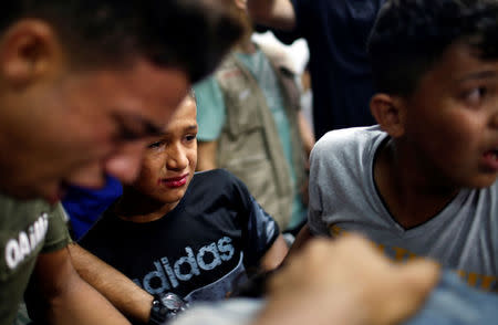 Relatives of a Palestinian, who was killed at the Israel-Gaza border, react at a hospital in Gaza City June 18, 2018. REUTERS/Mohammed Salem