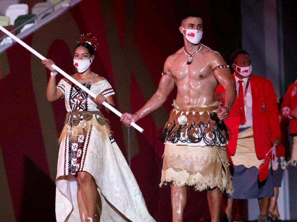 Pita Taufatofua of Team Tonga lead his team out during the Opening Ceremony while shirtless and covered in oil.