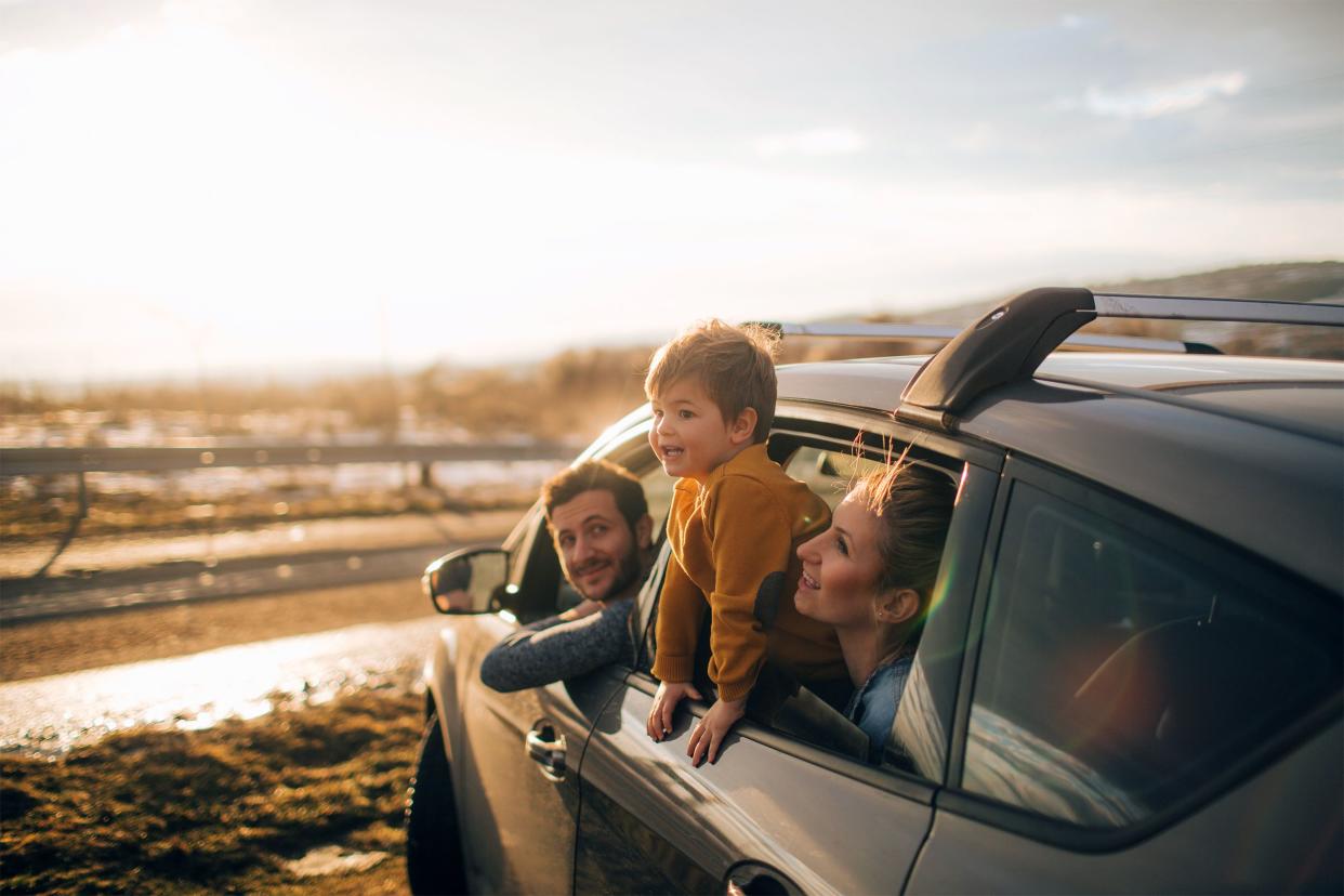 Family at the beach on a road trip in their car