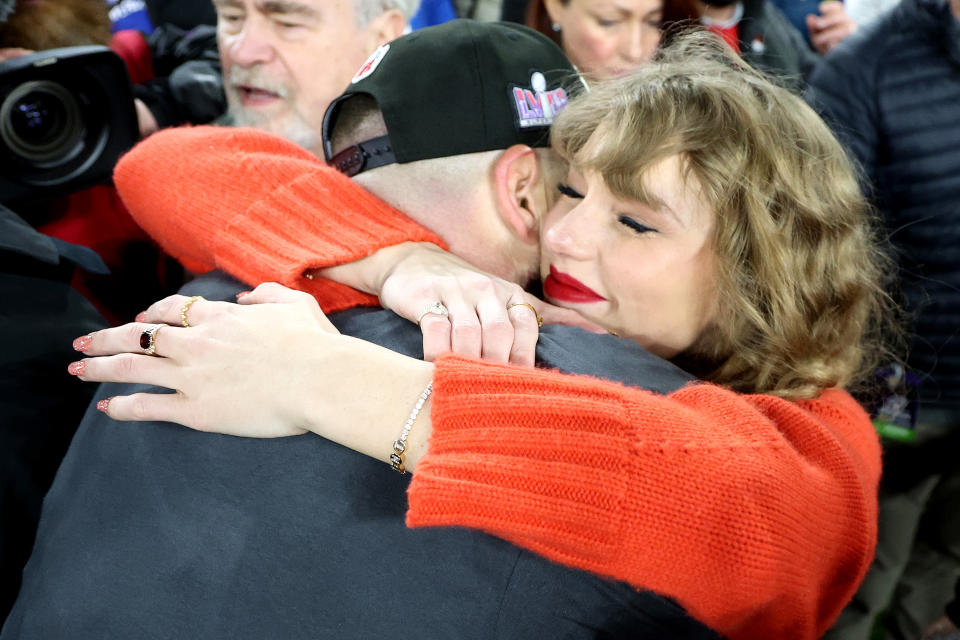 Taylor Swift hugging Travis Kelce