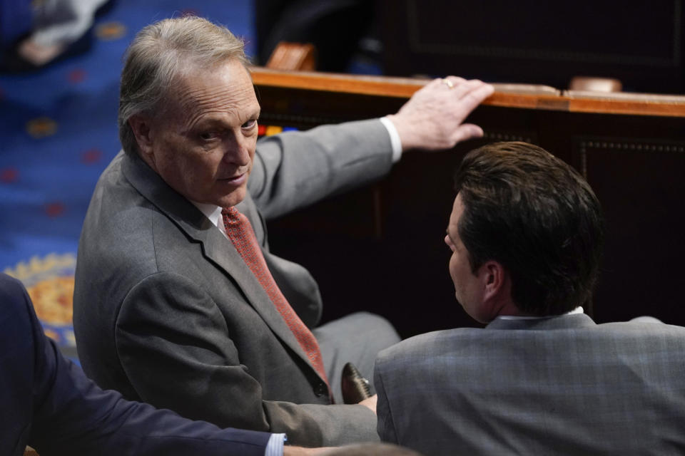 Rep. Andy Biggs, R-Ariz., turns as he speaks with Rep. Matt Gaetz, R-Fla., ahead of the 13th round of voting for speaker in the House chamber as the House meets for the fourth day to elect a speaker and convene the 118th Congress in Washington, Friday, Jan. 6, 2023. (AP Photo/Andrew Harnik)