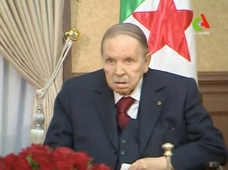 FILE PHOTO: Algeria's President Abdelaziz Bouteflika looks on during a meeting with army Chief of Staff Lieutenant General Gaid Salah in Algiers, Algeria, in this handout still image taken from a TV footage released on March 11, 2019. Algerian TV /Handout via Reuters/File Photo