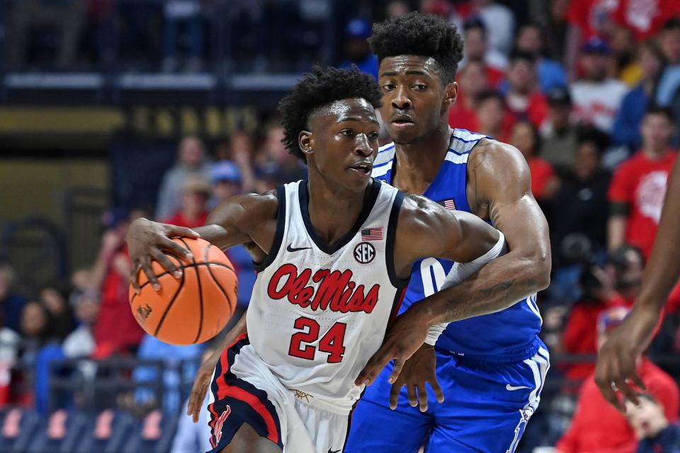 Mississippi guard Jarkel Joiner (24) drives the ball past Memphis guard Earl Timberlake (0) during the first half of an an NCAA college basketball game in Oxford, Miss., Saturday, Dec. 4, 2021. (AP Photo/Thomas Graning)