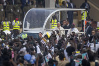 Pope Francis waves as he tours the audience in his vehicle after arriving for a Holy Mass at the John Garang Mausoleum in Juba, South Sudan Sunday, Feb. 5, 2023. Pope Francis is in South Sudan on the final day of a six-day trip that started in Congo, hoping to bring comfort and encouragement to two countries that have been riven by poverty, conflicts and what he calls a "colonialist mentality" that has exploited Africa for centuries. (AP Photo/Ben Curtis)