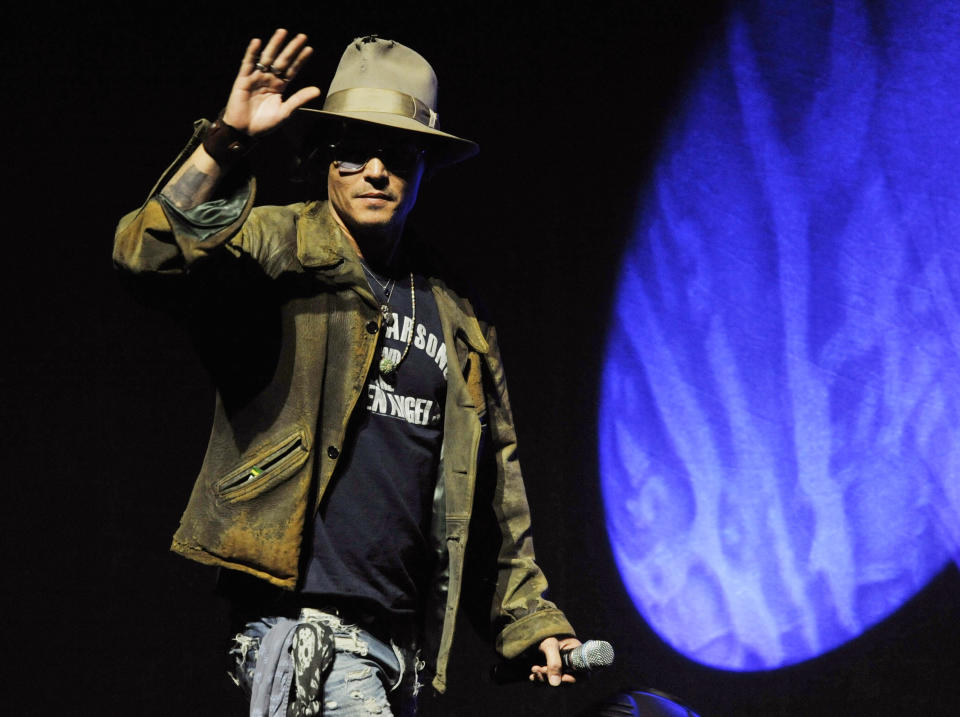 Johnny Depp, who plays Tonto in the upcoming film "The Lone Ranger," makes a surprise appearance onstage at the Walt Disney Studios presentation at CinemaCon 2013 at Caesars Palace on Wednesday, April 17, 2013 in Las Vegas. (Photo by Chris Pizzello/Invision/AP)