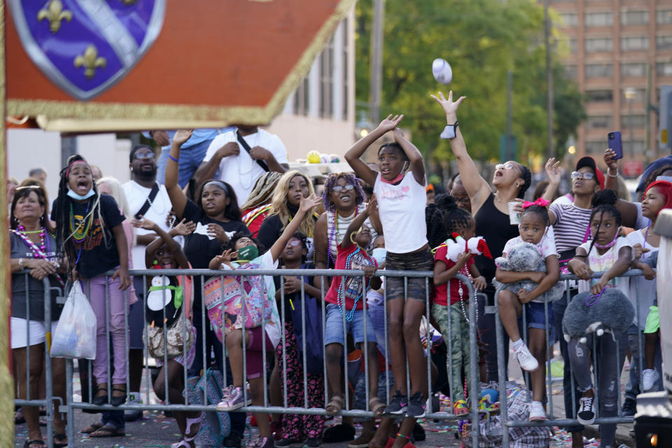 Parade-goers vie for throws during a parade dubbed "Tardy Gras," to compensate for a cancelled Mardi Gras due to the COVID-19 pandemic, in Mobile, Ala., Friday, May 21, 2021. (AP Photo/Gerald Herbert)