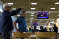 <p>People watch coverage of President Trump’s meeting with North Korean leader Kim Jong Un. (Photo: Jae C. Hong/AP) </p>