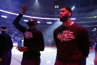 Los Angeles Lakers' Anthony Davis, right, and LeBron James stand during the national anthem before the start of an NBA basketball game against the New Orleans Pelicans Tuesday, Feb. 25, 2020, in Los Angeles. (AP Photo/Marcio Jose Sanchez)