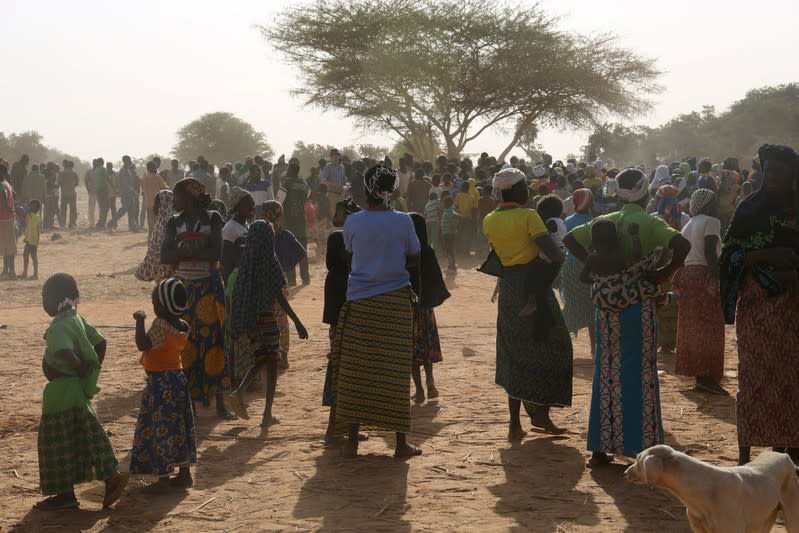 Displaced people wait for help at a village in Dablo area