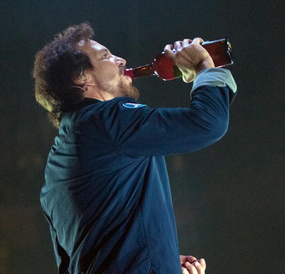 Eddie Vedder of Pearl Jam takes a drink between songs at the DCU Center. [Betty Jenewin, T&G Staff/BETTY JENEWIN]