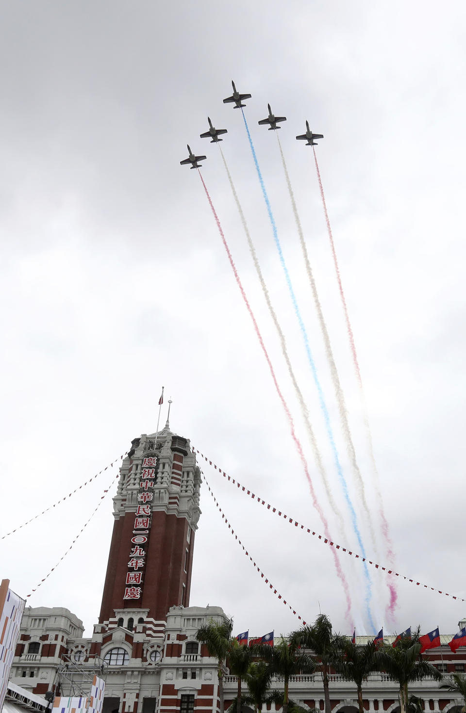 Thunder Tiger Aerobatics Team fly over President Office during the National Day celebrations in Taipei, Taiwan, Saturday, Oct. 10, 2020. Taiwanese President Tsai Ing-wen said Saturday she has hopes for less tensions with China and in the region if Beijing will listen to Taipei’s concerns, alter its approach and restart dialogue with the self-ruled island democracy. (AP Photo/Chiang Ying-ying)