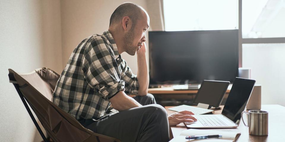 man using laptop computer and tablet working